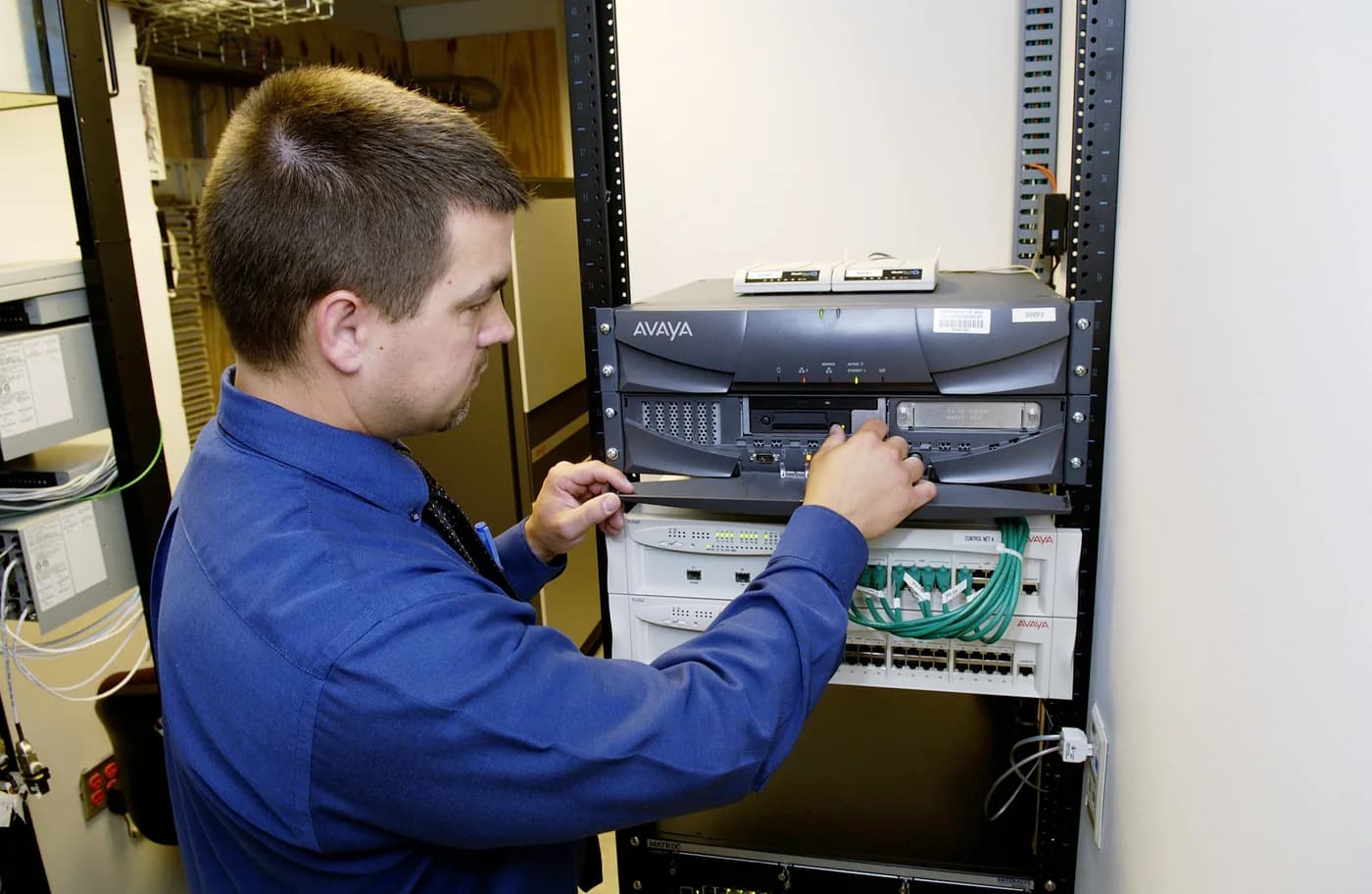 A technician working with network server equipment