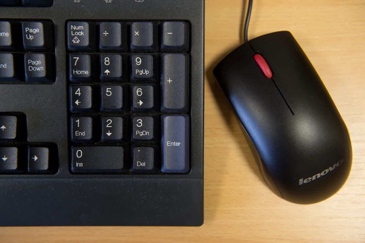 A Lenovo keyboard and mouse, shown as a workplace reference