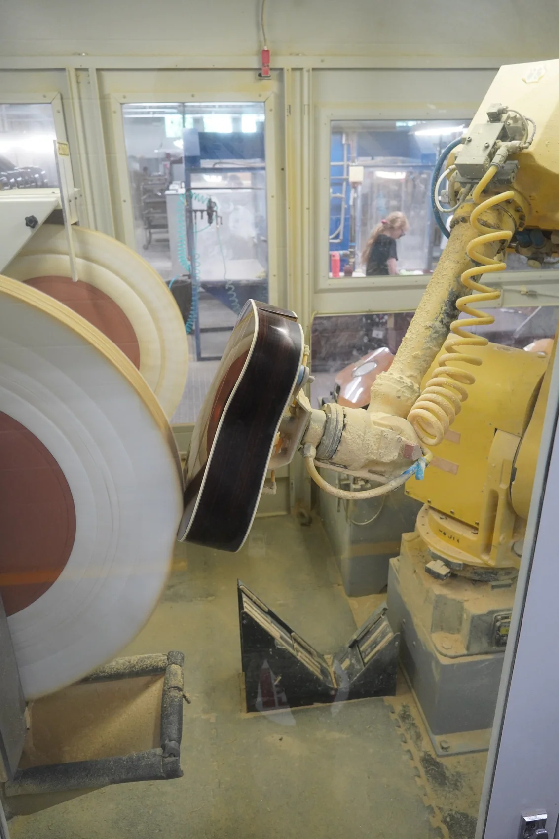 A robotic arm polishing a guitar at the Martin Guitar factory
