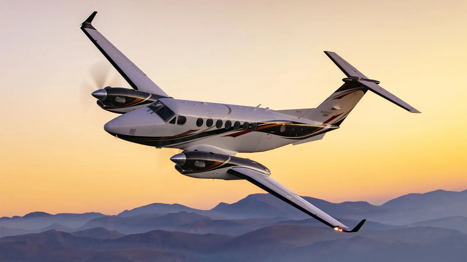 Private aircraft above mountain scenery at sunset, as pictured in Jet.Live’s aircraft guide