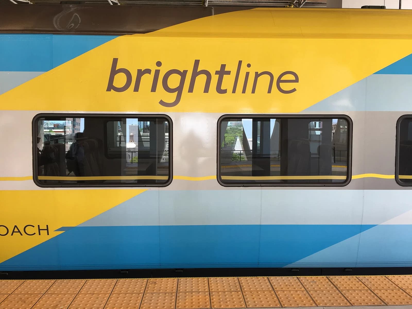 A Brightline train at Miami station, with its yellow and blue exterior