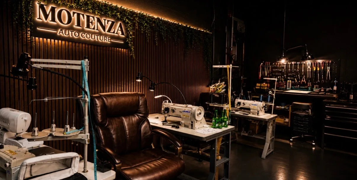 Motenza Auto Couture atelier with sewing machines and illuminated signage in Hollywood, Florida