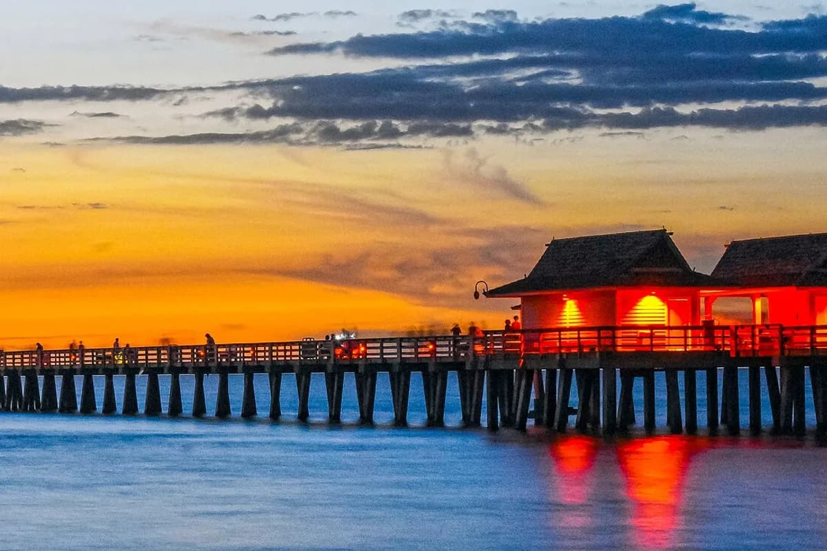 Naples coastline and historic pier at sunset in an archival photograph