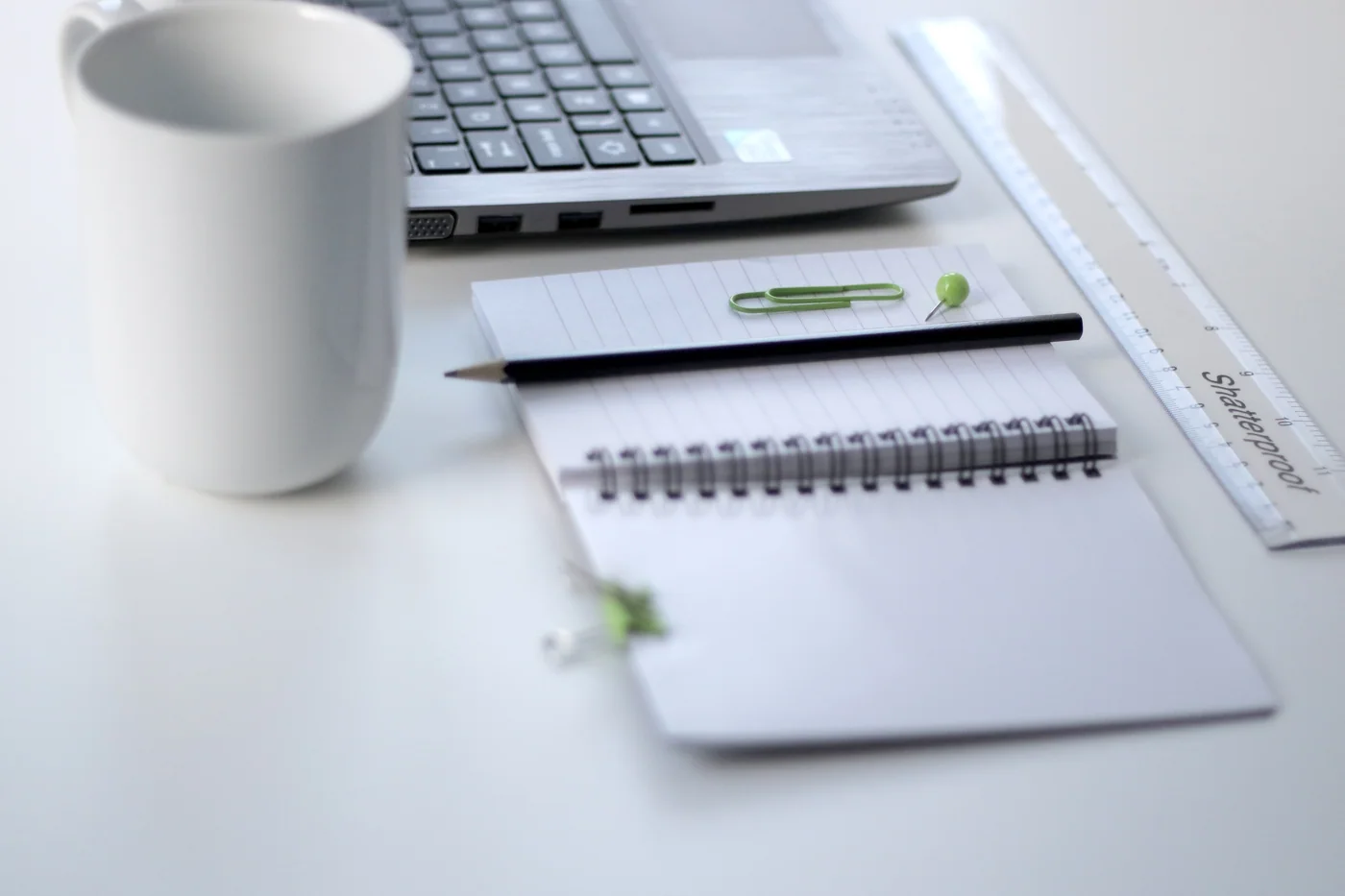 A ruler and laptop on a desk, shown as a workspace reference