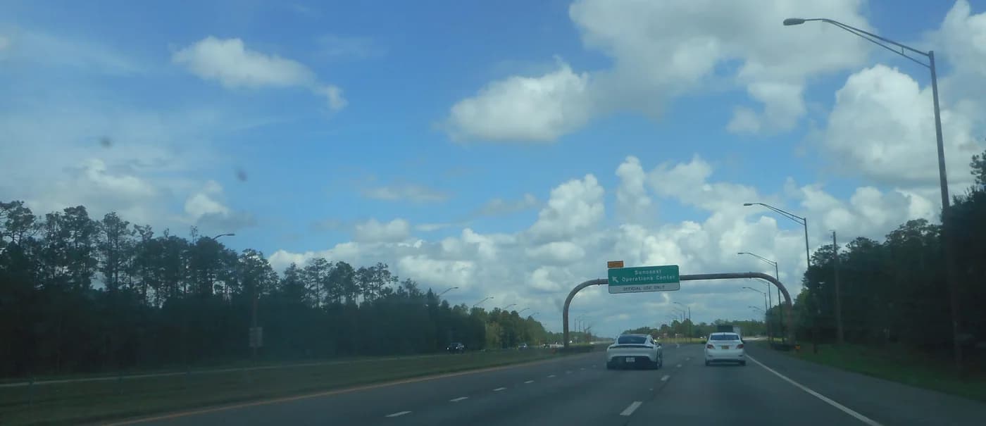 An archival road sign near a Florida toll plaza