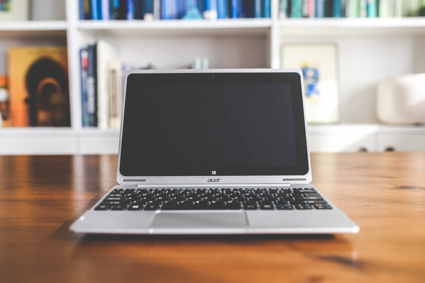 Reference photograph of a laptop and notebook on a table