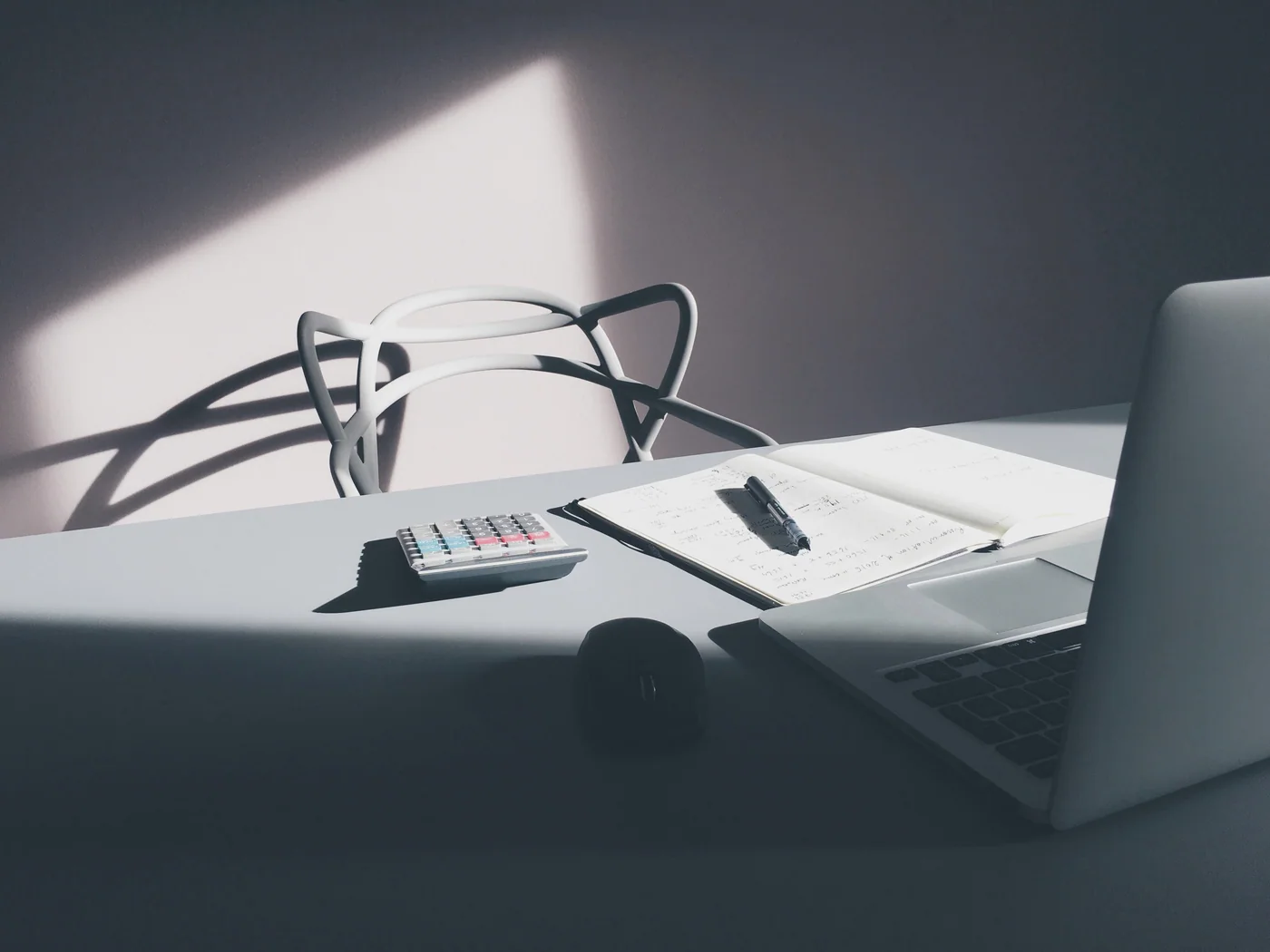 Reference photograph of a laptop and calculator on a desk