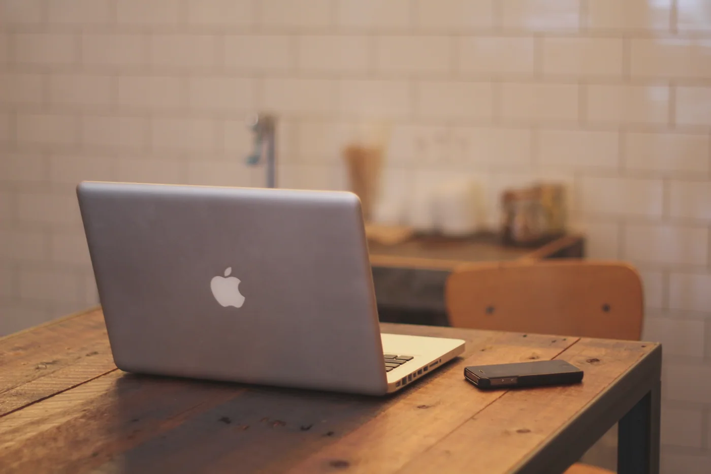 Reference photograph of a smartphone beside a laptop on a desk