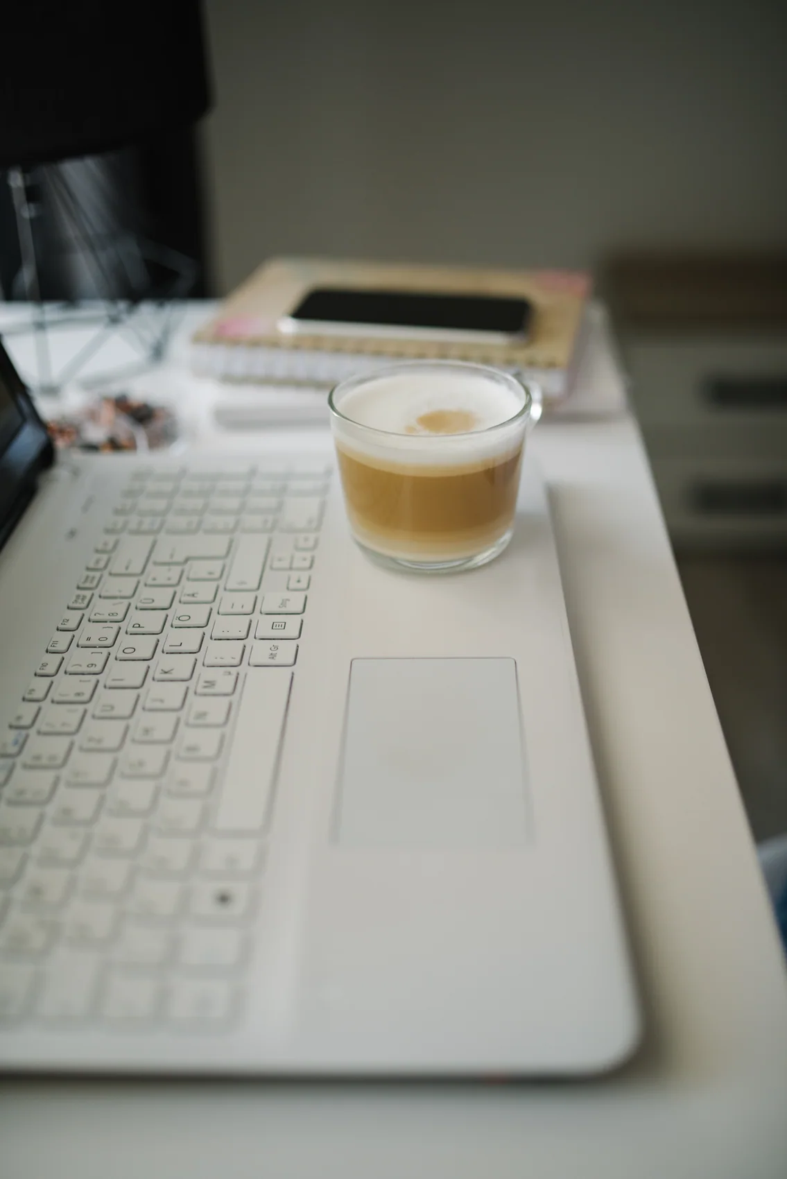 A desk workspace with coffee, shown as a personal-budgeting reference