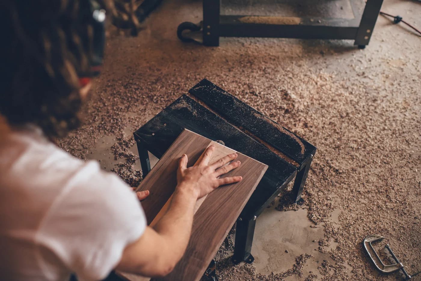 A woodworker in a workshop, shown as a business-operations reference