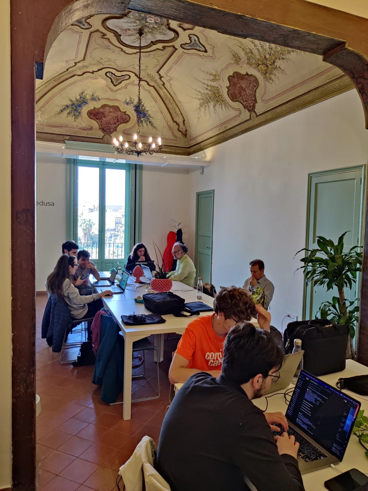 People working at a coworking event in Catania