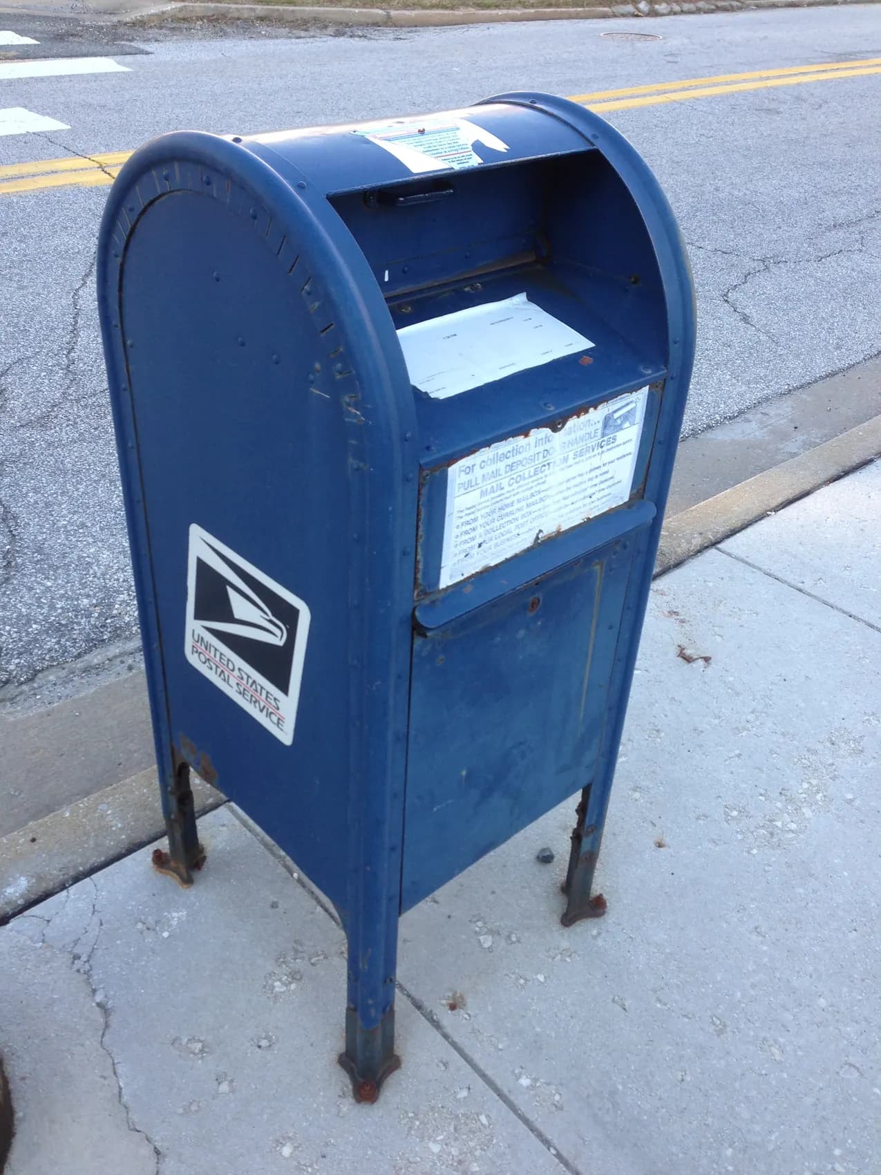 A blue USPS collection mailbox