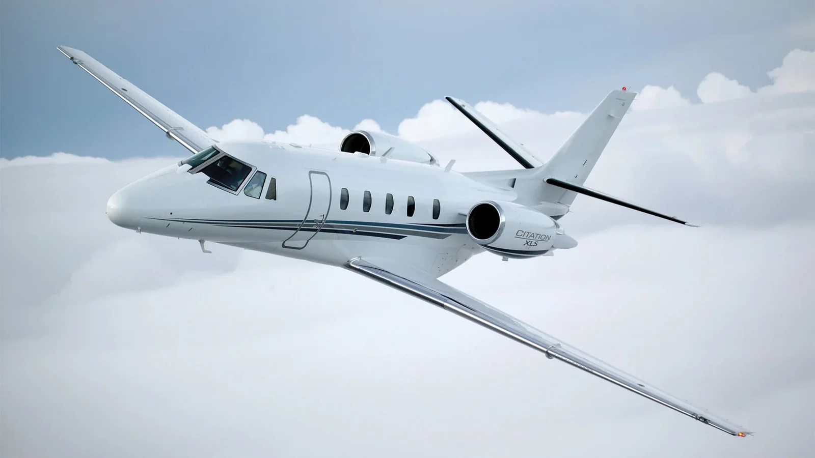 White private aircraft above clouds, as pictured in Jet.Live’s aircraft guide