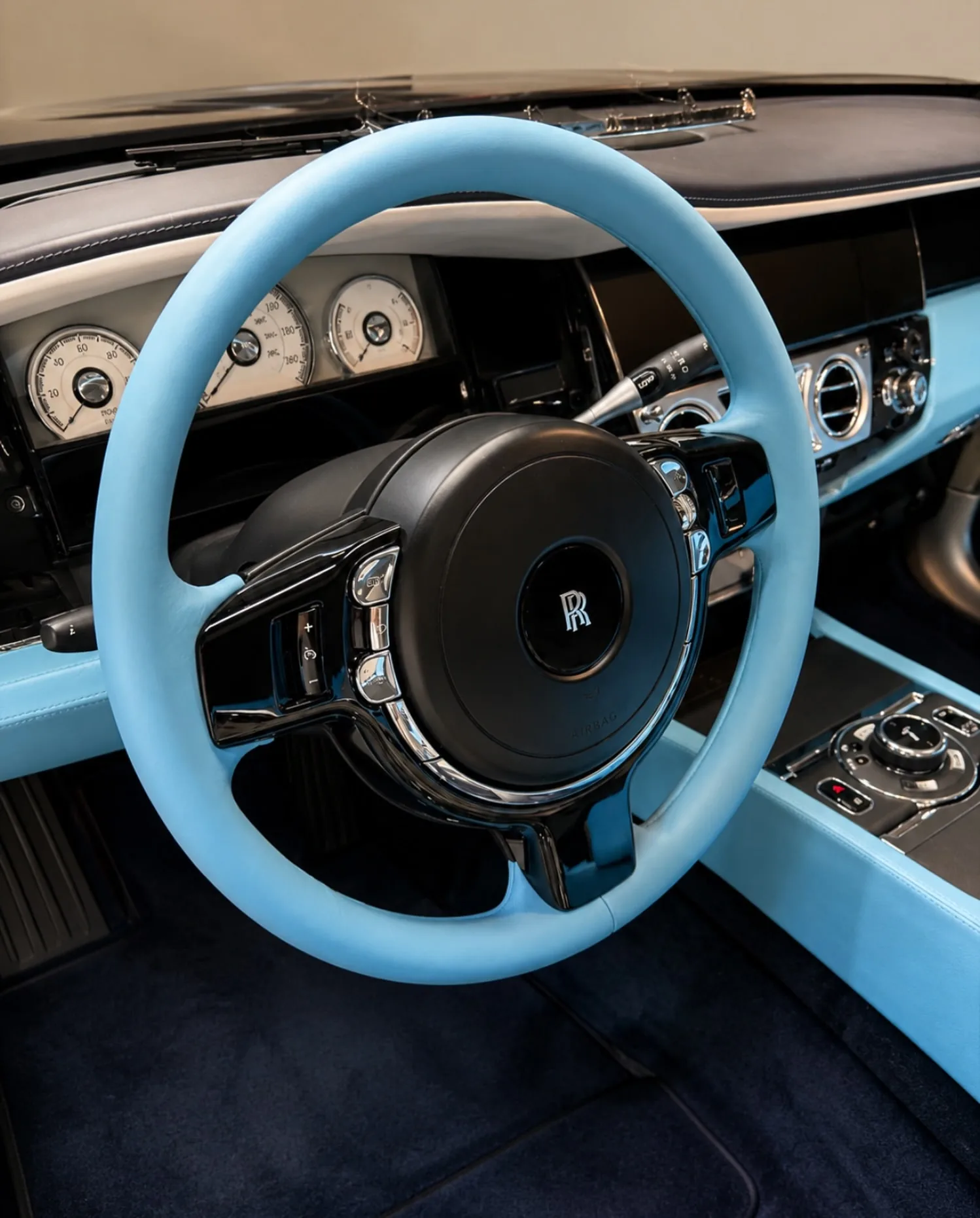 Miami Blue leather steering wheel and dashboard trim in a Motenza Rolls-Royce project